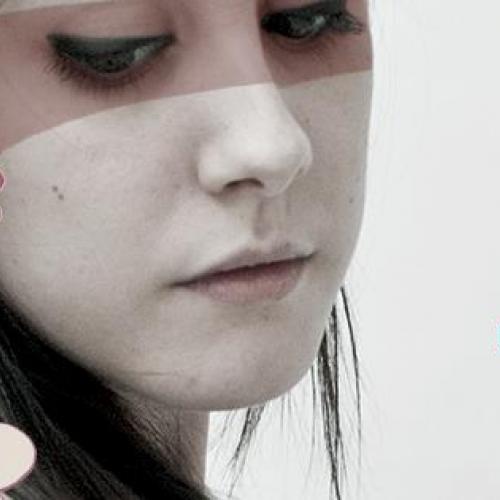 Portrait of a woman's face with blue and purple flowers drawn over her hair. Trophy Scars with Nigel Silverthorn. Summer 2013.